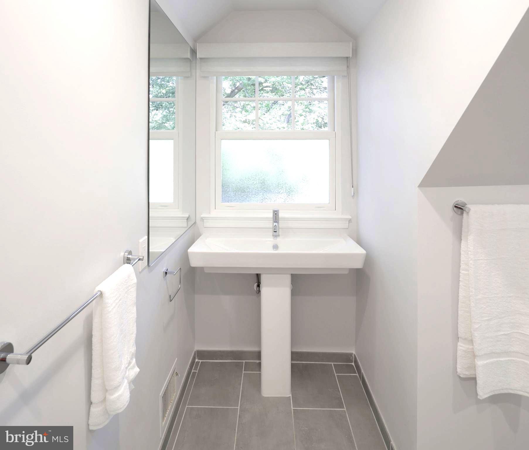 3137 Aberfoyle Place Northwest Washington, DC 20015 - Photo 56 of 85 a bathroom with a sink a mirror and a window