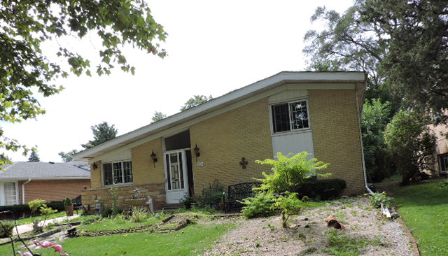 9234 Kolmar Avenue Skokie, IL 60076 - Photo 2 of 3 a front view of a house with garden