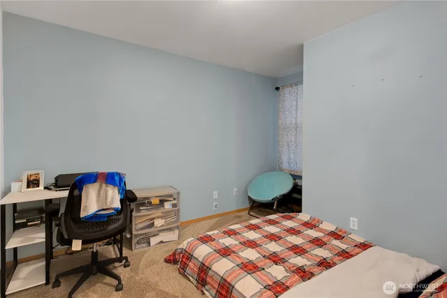 a bedroom with a bed a desk and chair