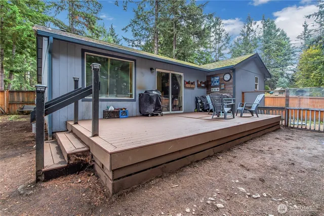 a view of house with backyard outdoor seating and hardwood