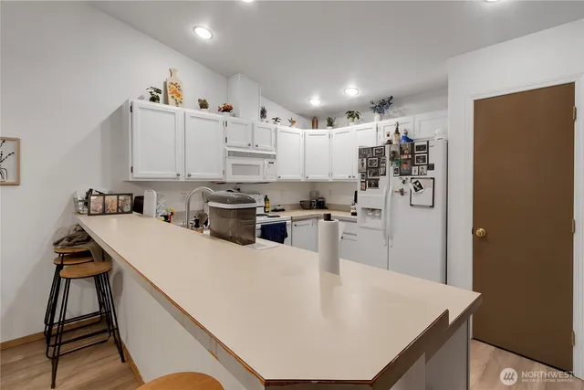 a kitchen with stainless steel appliances granite countertop refrigerator sink and cabinets