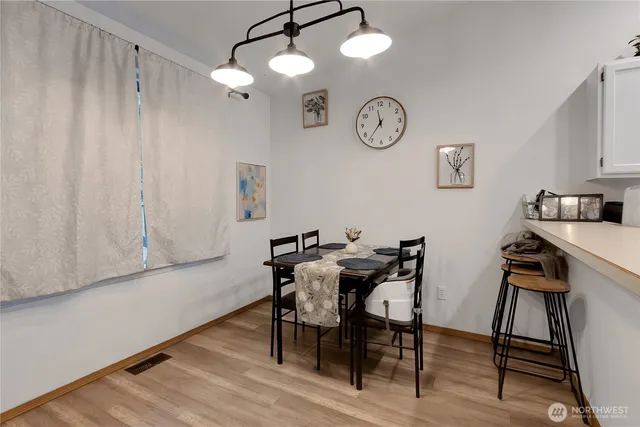 a view of a room with furniture and wooden floor