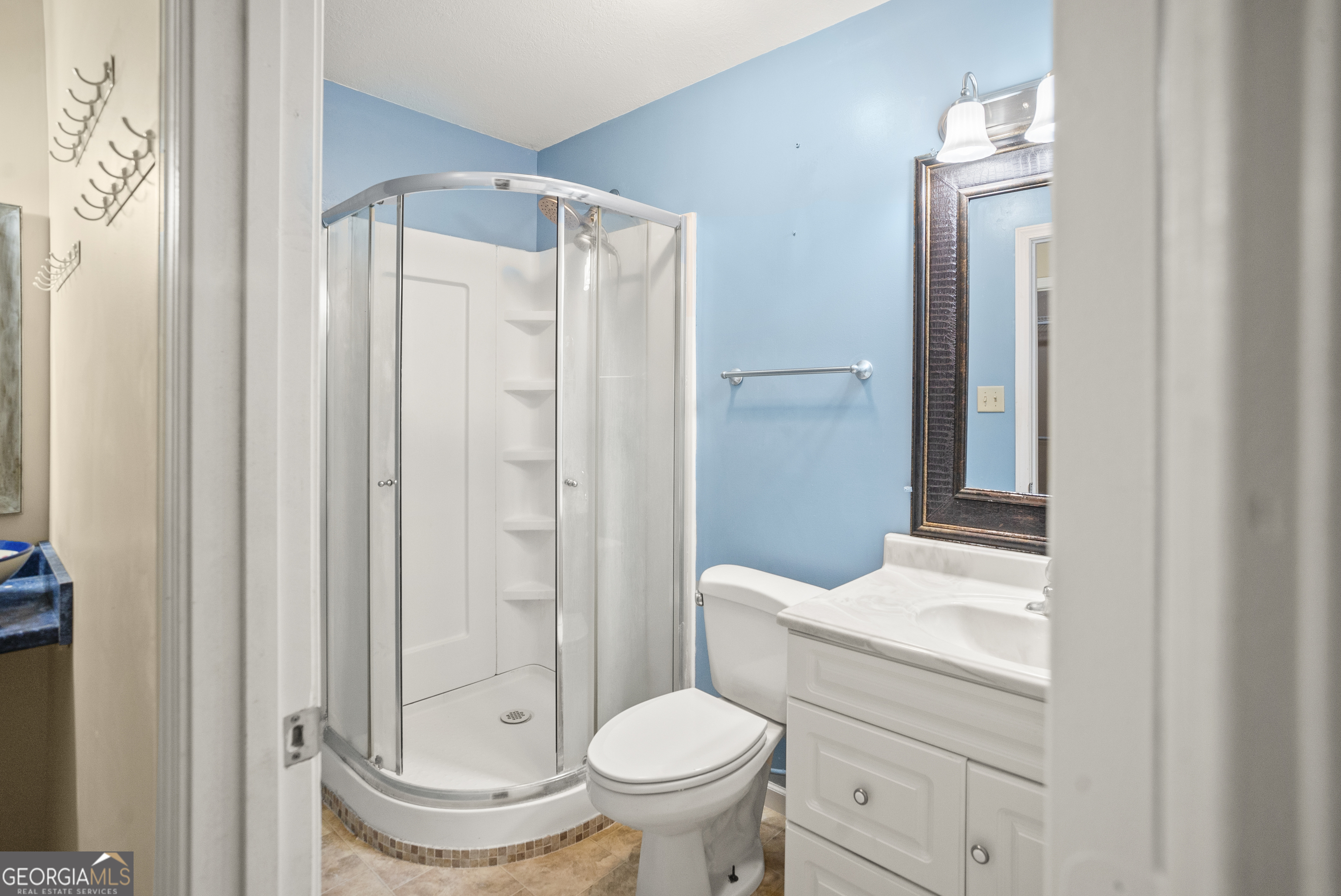 101 Ridge Drive Claxton, GA 30417 - Photo 11 of 30 a bathroom with a toilet a sink and a mirror