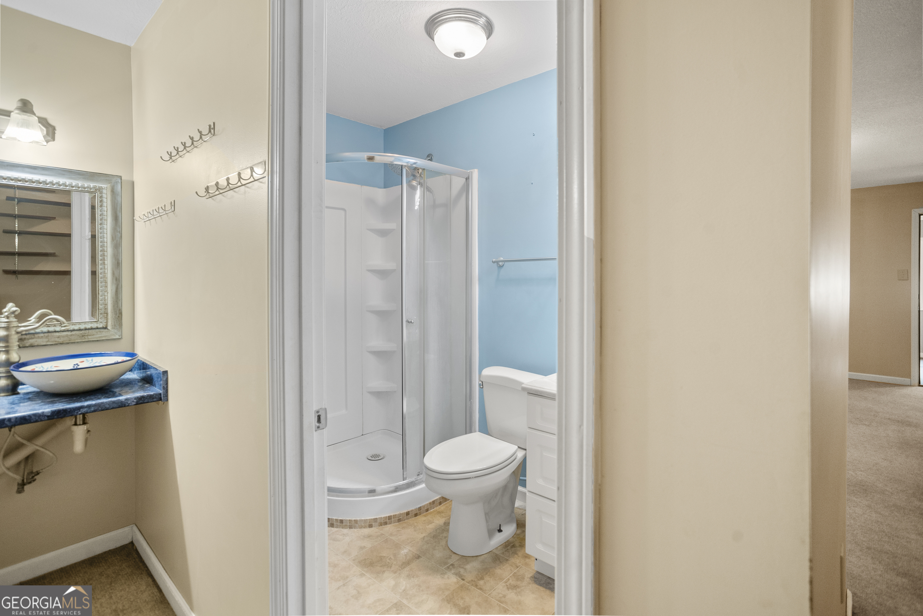 101 Ridge Drive Claxton, GA 30417 - Photo 12 of 30 a bathroom with a granite countertop sink a toilet a mirror and shower