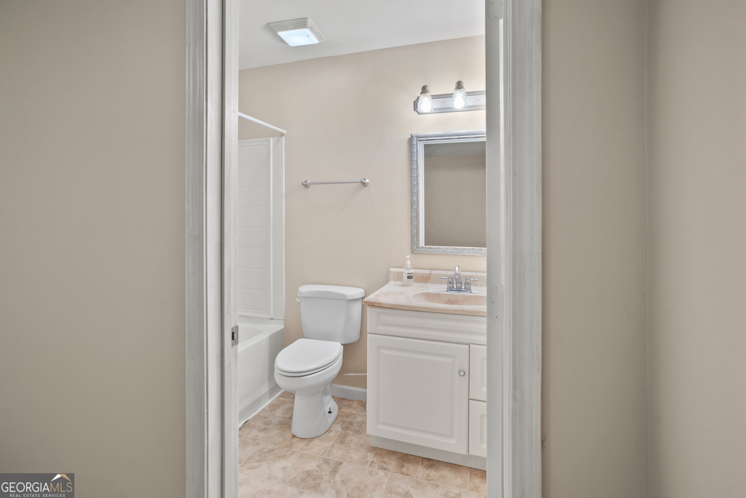 101 Ridge Drive Claxton, GA 30417 - Photo 19 of 30 a bathroom with a granite countertop toilet a sink and a mirror