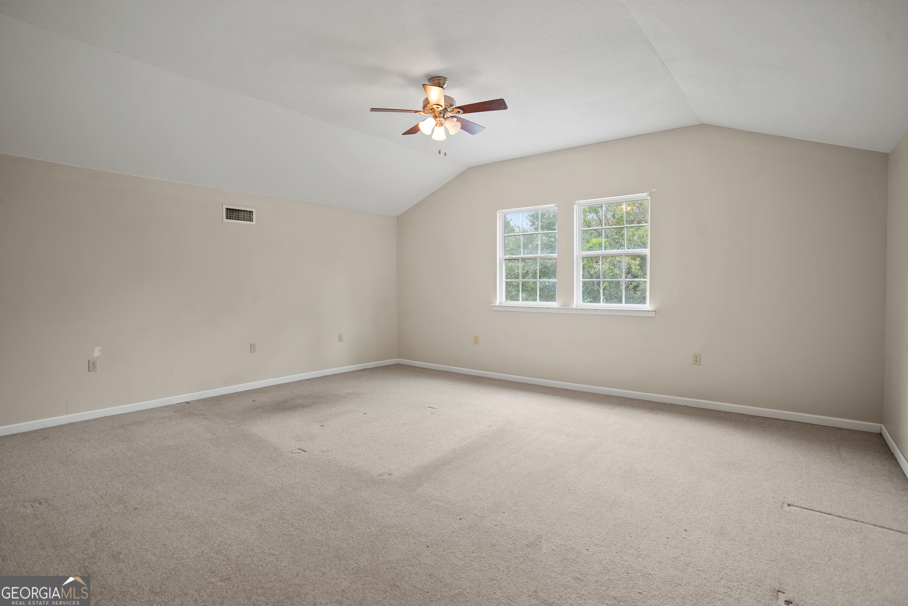 101 Ridge Drive Claxton, GA 30417 - Photo 21 of 30 an empty room with a window and a ceiling fan