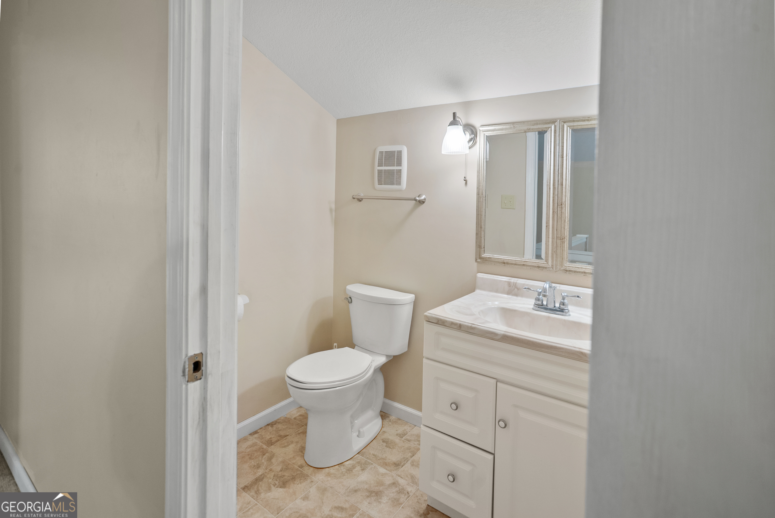 101 Ridge Drive Claxton, GA 30417 - Photo 22 of 30 a bathroom with a toilet sink vanity and mirror