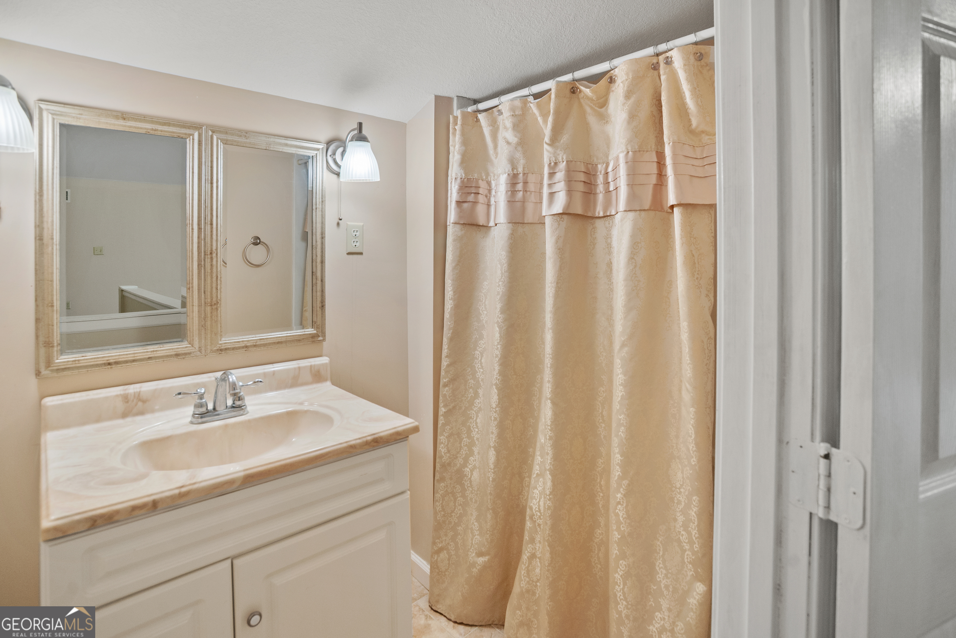 101 Ridge Drive Claxton, GA 30417 - Photo 23 of 30 a bathroom with a shower curtain and a sink