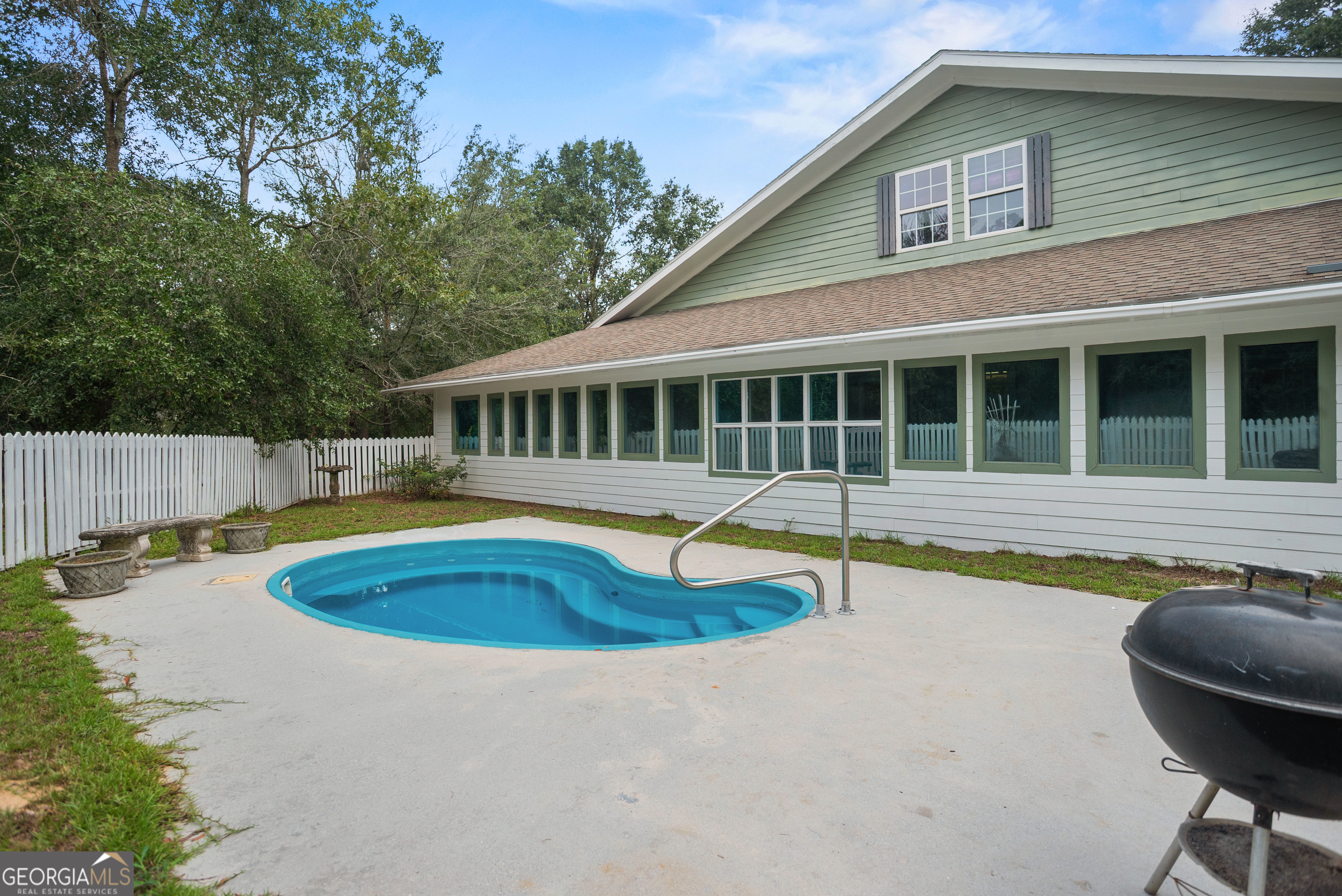 101 Ridge Drive Claxton, GA 30417 - Photo 28 of 30 a view of swimming pool with lawn chairs and plants