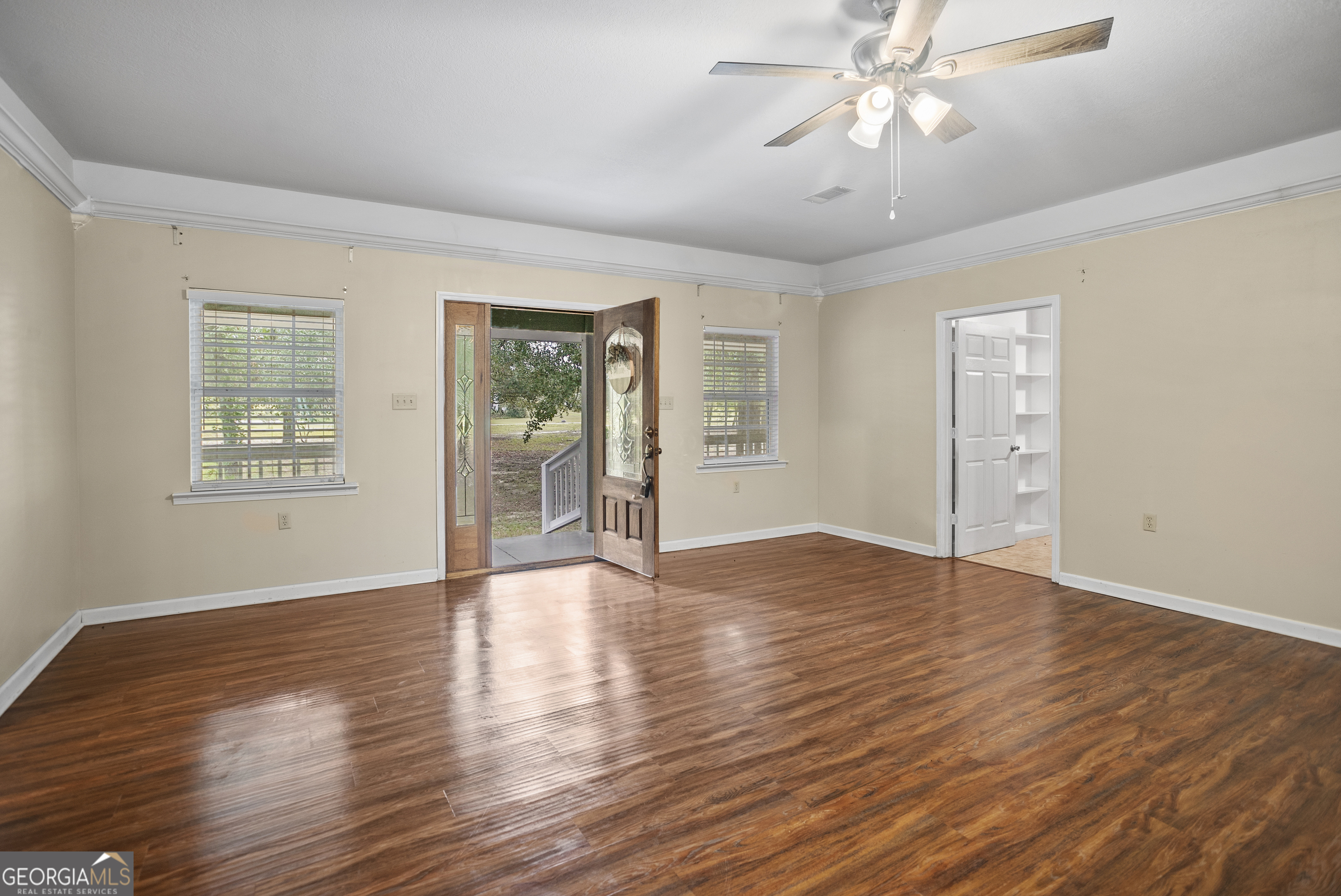 101 Ridge Drive Claxton, GA 30417 - Photo 4 of 30 a view of an empty room with wooden floor and a window