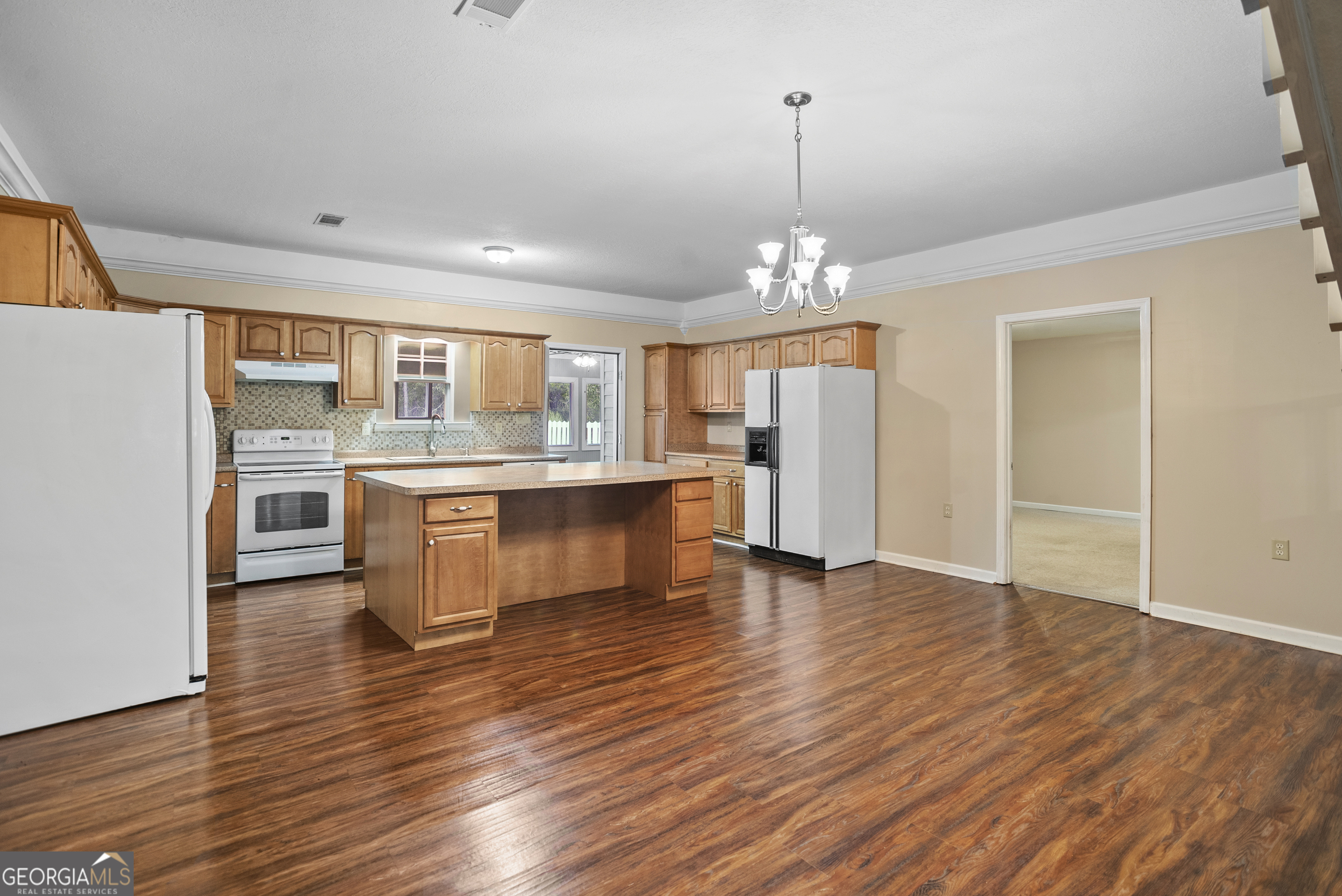 101 Ridge Drive Claxton, GA 30417 - Photo 7 of 30 a view of kitchen with granite countertop cabinets and wooden floor