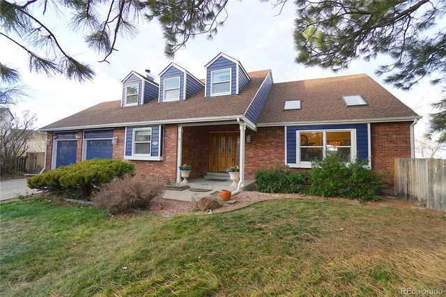 a front view of a house with garden and porch