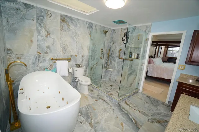 a view of bathroom with bathtub and shower