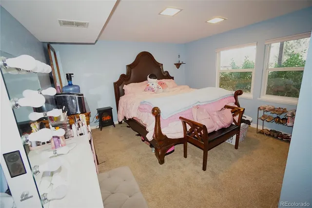 a bed room with a bed and a chair