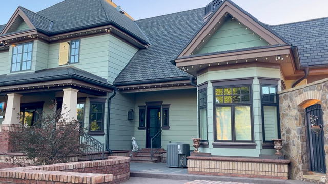 426 West Center Street Parowan, UT 84761 - Photo 85 of 107 Exterior featuring a detailed bay window, stone wall with arched entry, multi-pane windows, and a dark shingle roof