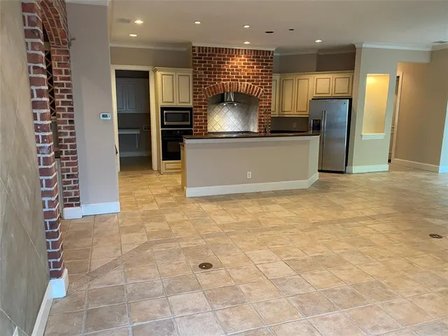 a kitchen with stainless steel appliances granite countertop a refrigerator and a sink