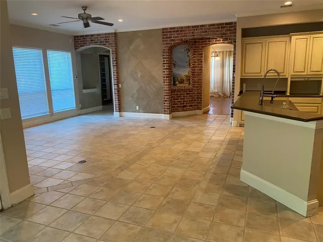 a view of a kitchen with a sink and a refrigerator