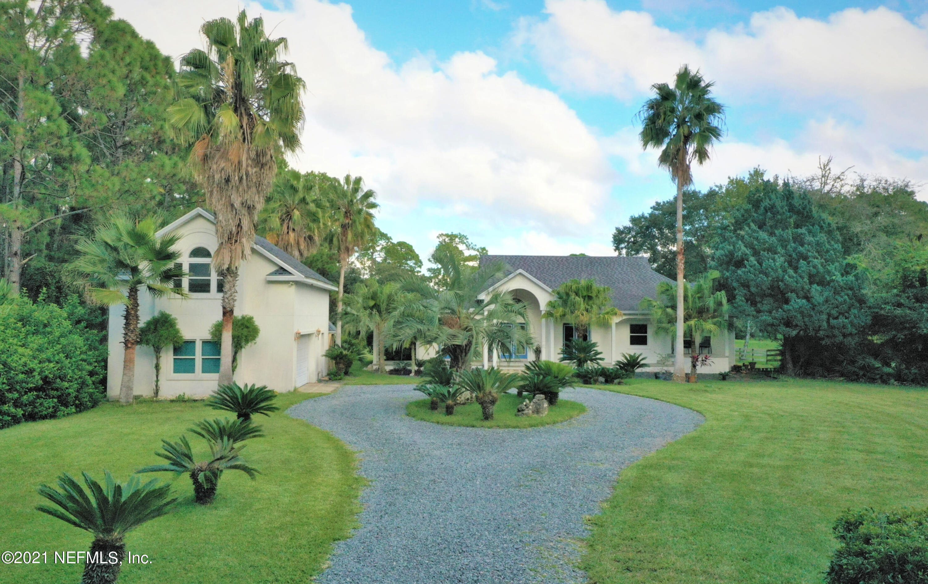 a view of a garden with a building in the background