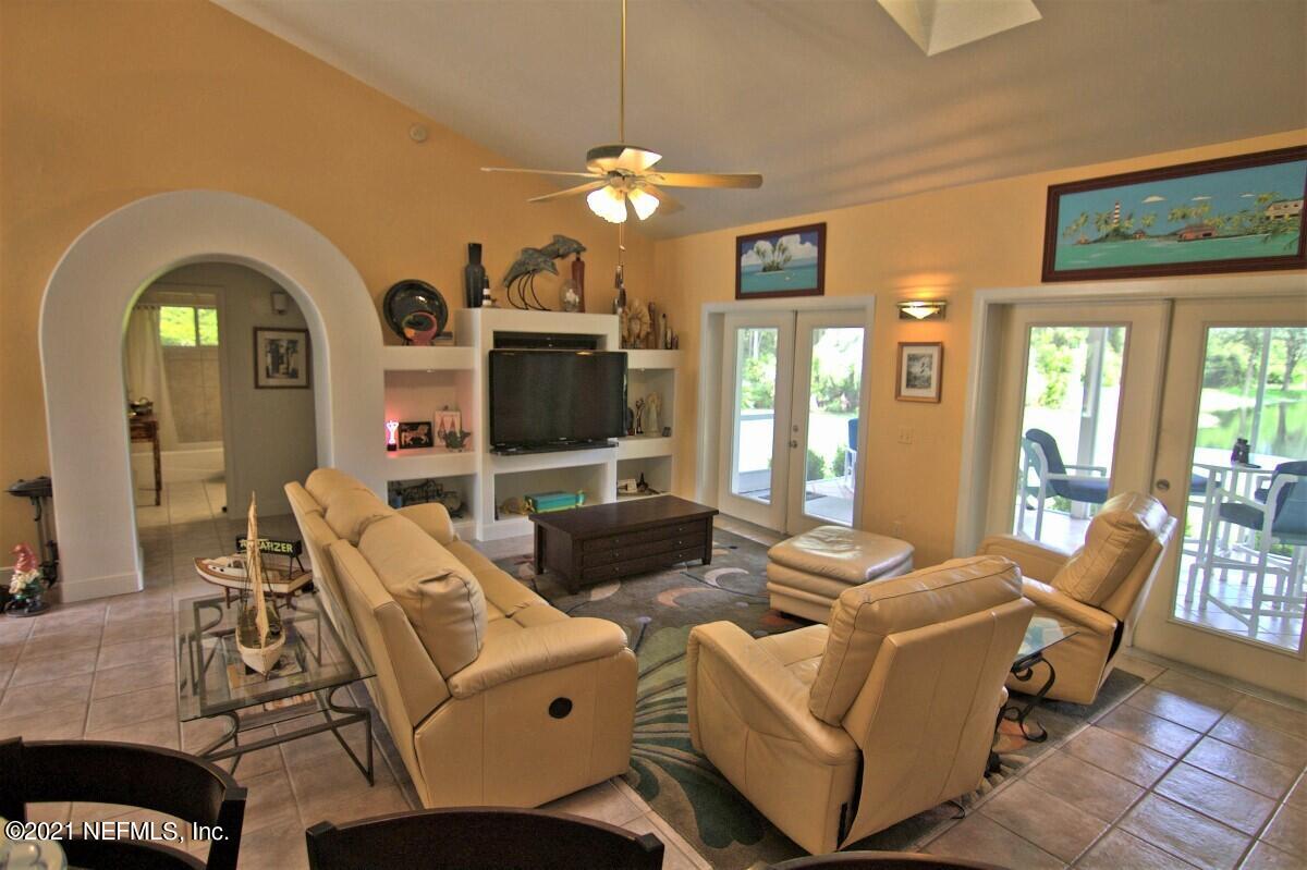 1365 Highway 206 St. Augustine, FL 32086 - Photo 14 of 54 a living room with furniture a chandelier and a flat screen tv