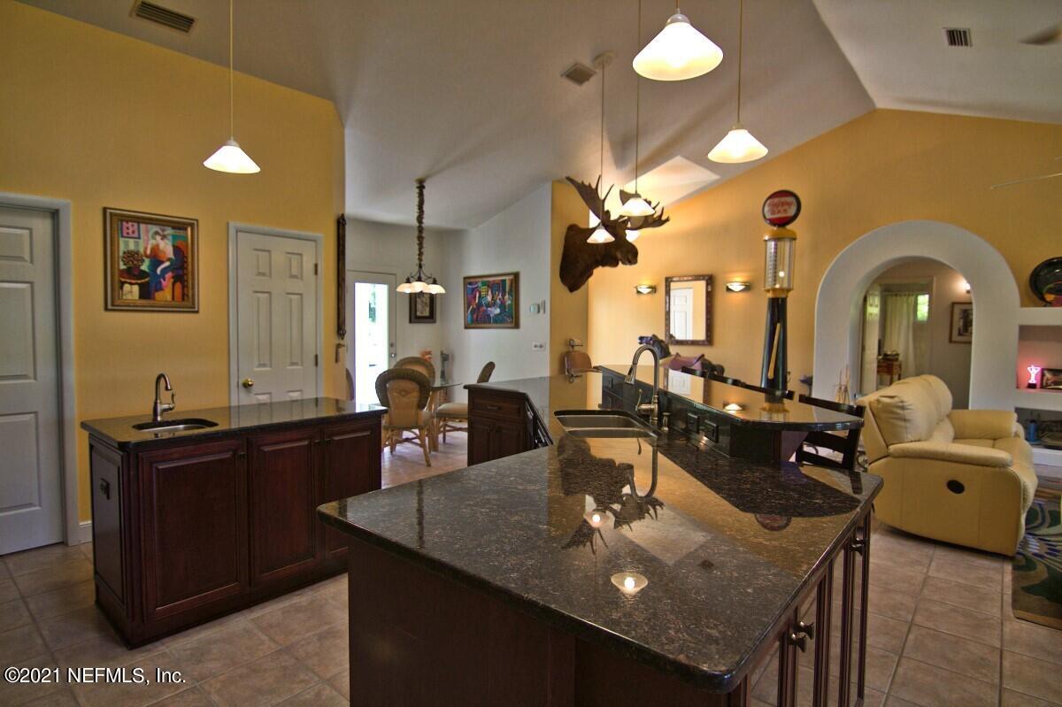 1365 Highway 206 St. Augustine, FL 32086 - Photo 17 of 54 a view of a dining room with furniture and a chandelier