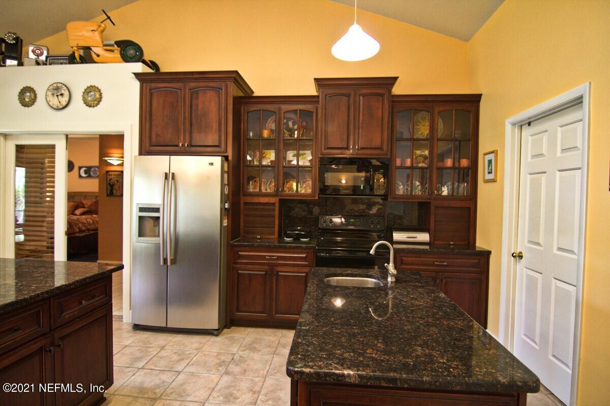 1365 Highway 206 St. Augustine, FL 32086 - Photo 18 of 54 a kitchen with refrigerator and table