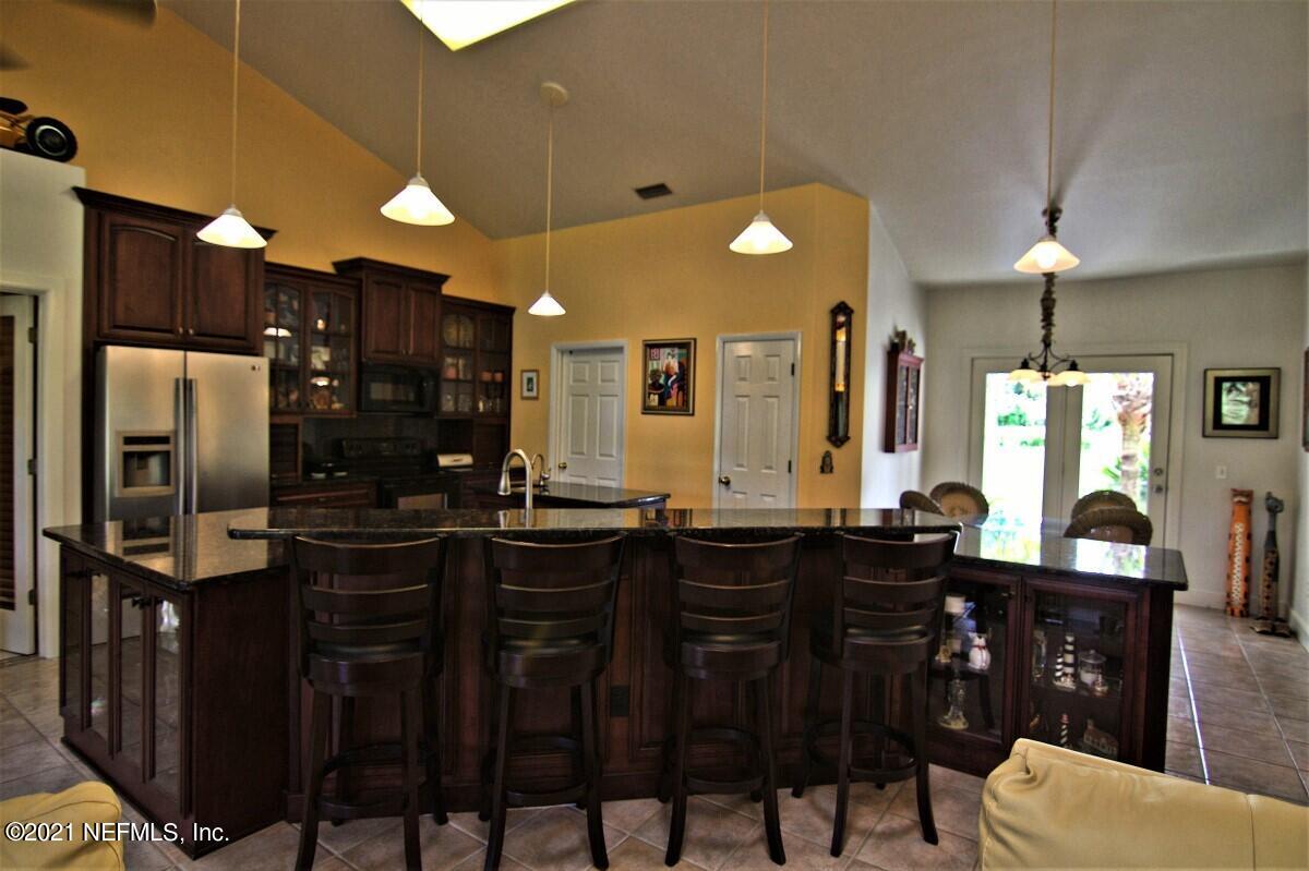 1365 Highway 206 St. Augustine, FL 32086 - Photo 19 of 54 a kitchen with a table chairs sink and cabinets