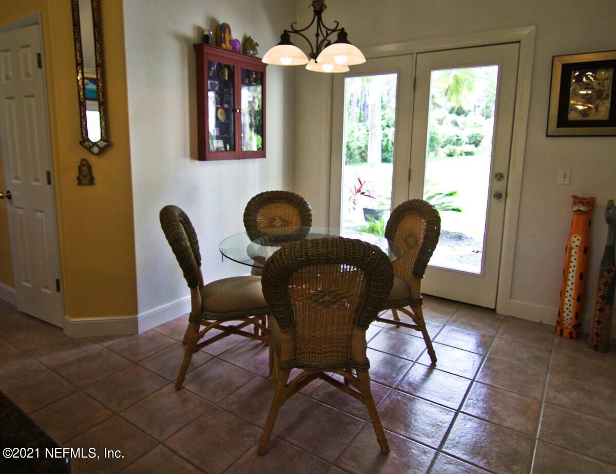 1365 Highway 206 St. Augustine, FL 32086 - Photo 20 of 54 a view of a dining room with furniture and chandelier
