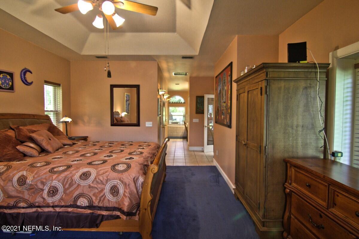 1365 Highway 206 St. Augustine, FL 32086 - Photo 26 of 54 a bedroom with a bed and wooden floor