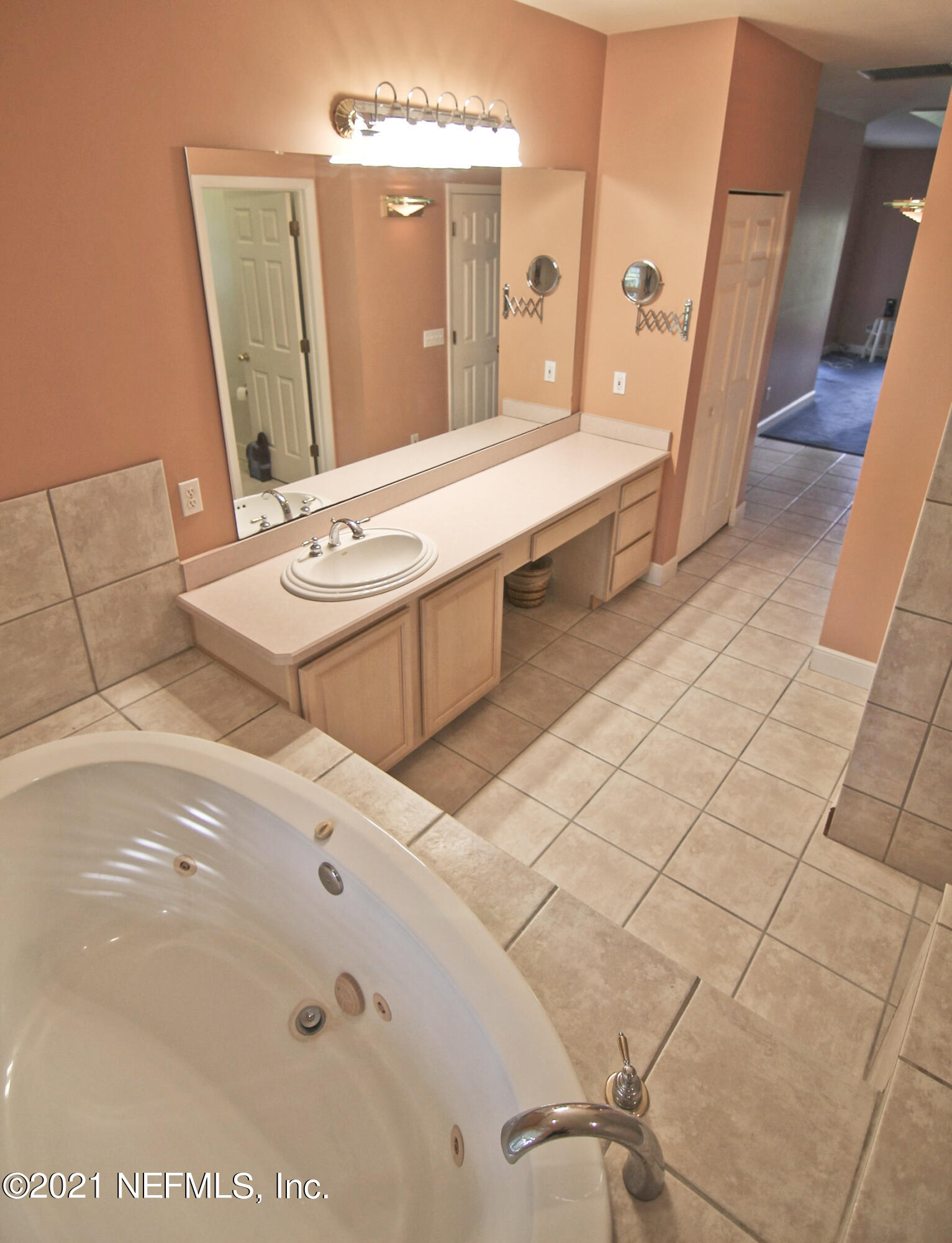1365 Highway 206 St. Augustine, FL 32086 - Photo 28 of 54 a bathroom with a double vanity sink and mirror