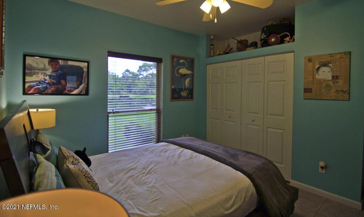 1365 Highway 206 St. Augustine, FL 32086 - Photo 31 of 54 a bedroom with a bed and a painting on the wall