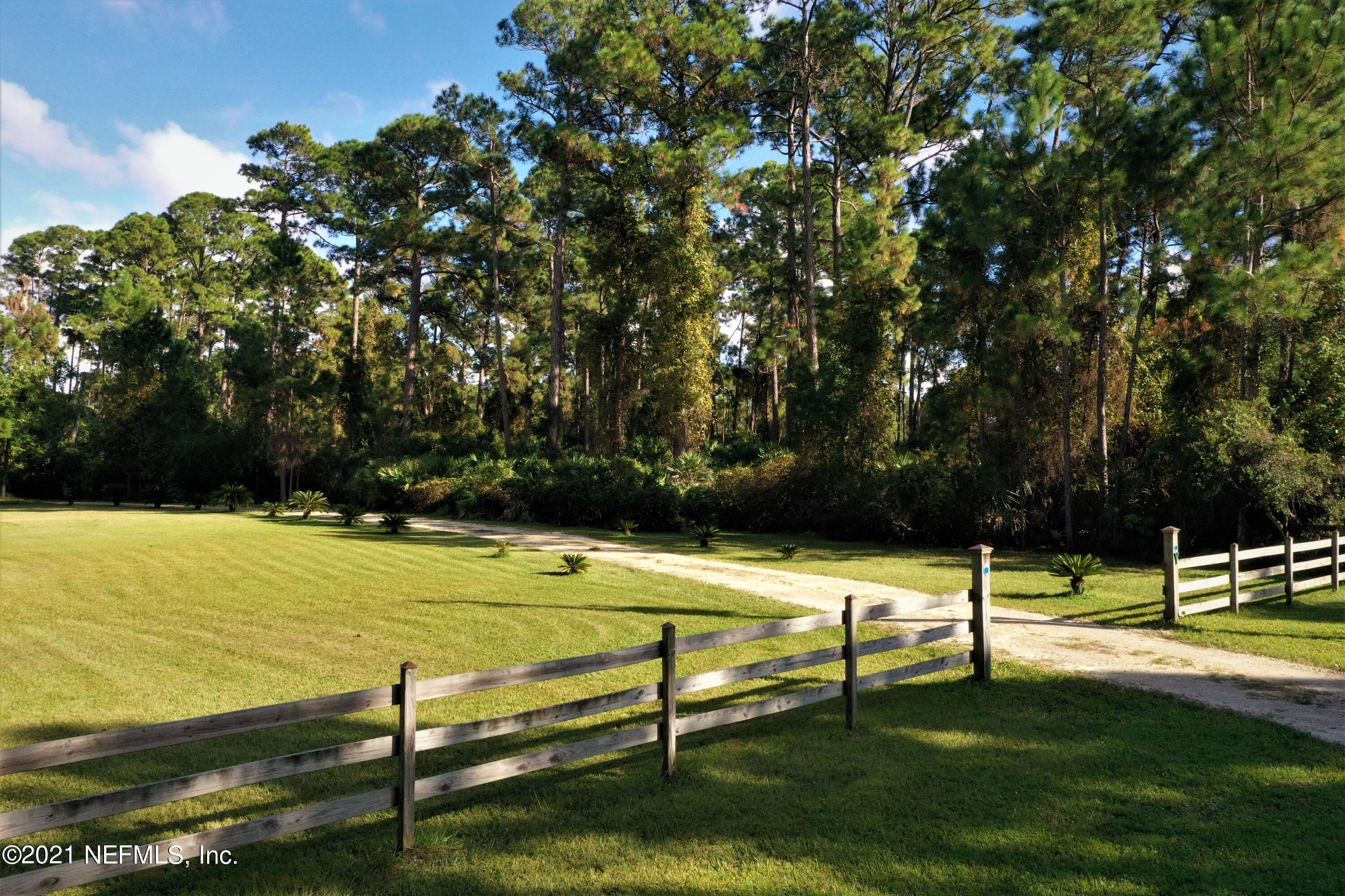 1365 Highway 206 St. Augustine, FL 32086 - Photo 42 of 54 a view of a tennis ground with large trees