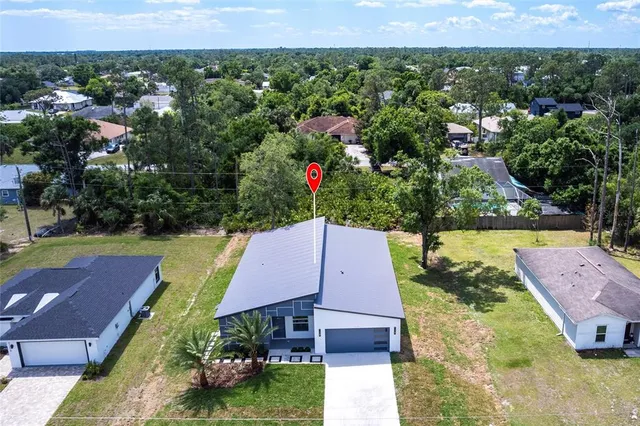 an aerial view of a houses with a yard