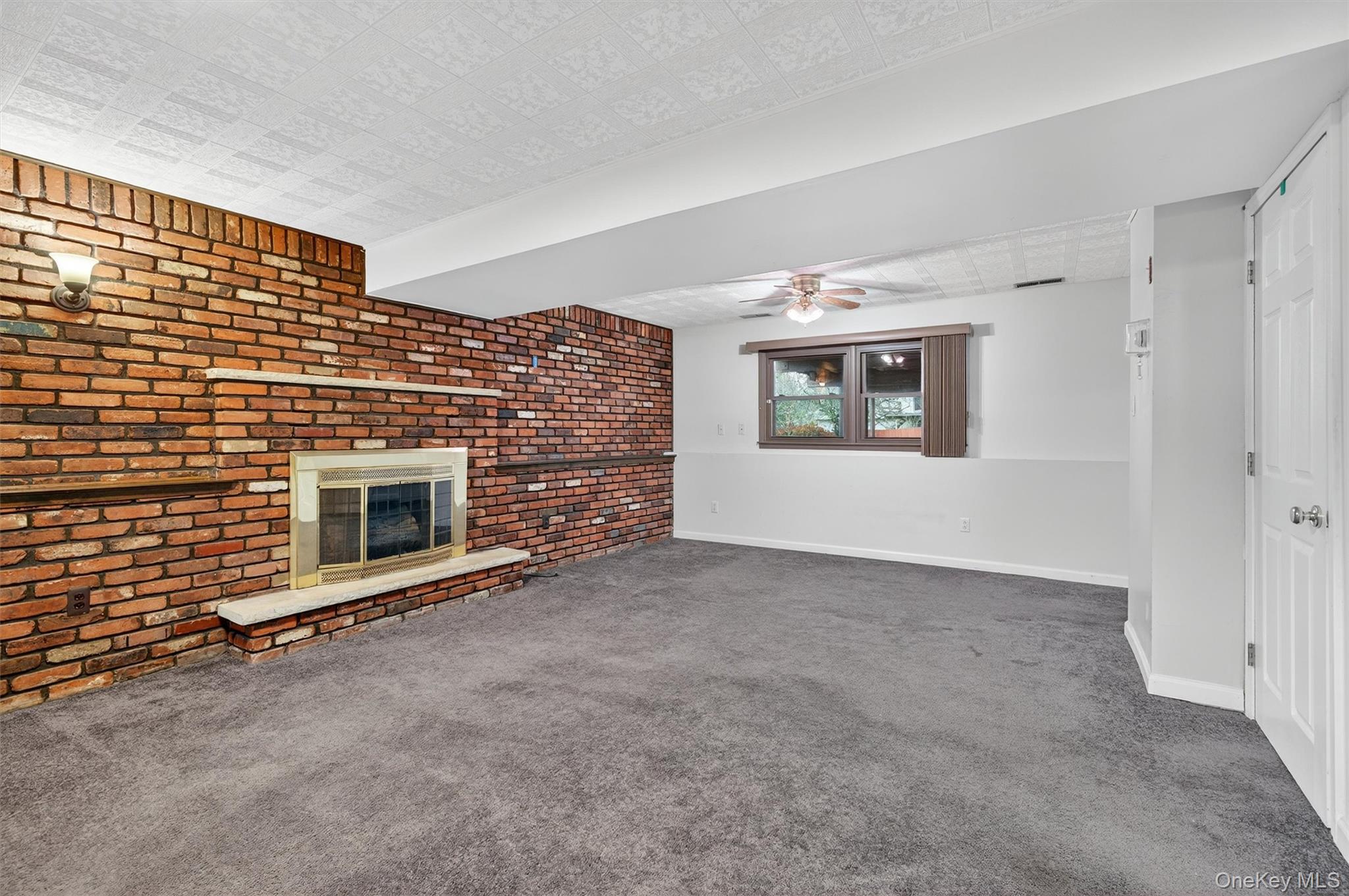 8 Badami Drive Middletown, NY 10941 - Photo 28 of 42 a view of an empty room with a fireplace and a window