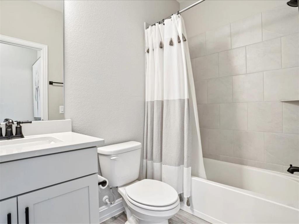 4828 Nicola Road Dallas, TX 75228 - Photo 18 of 38 a bathroom with a sink toilet and shower
