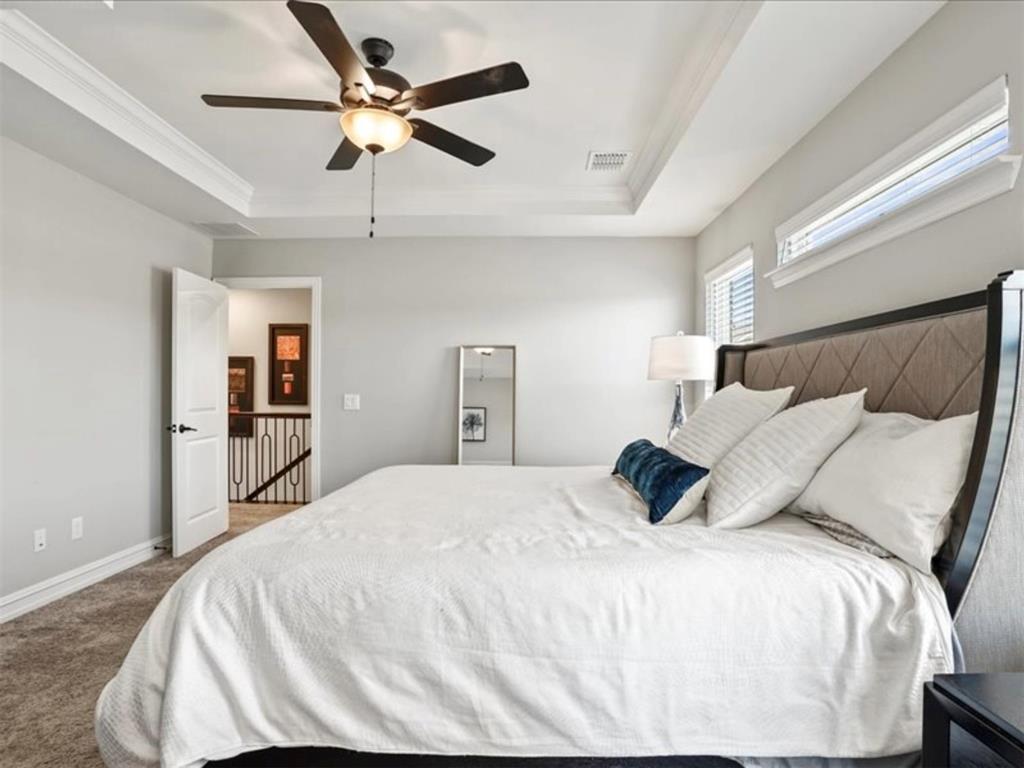 4828 Nicola Road Dallas, TX 75228 - Photo 23 of 38 a bedroom with a bed and a ceiling fan