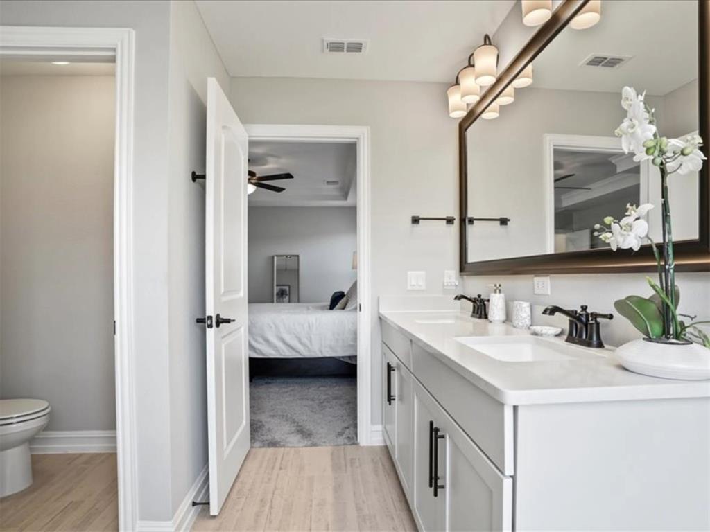 4828 Nicola Road Dallas, TX 75228 - Photo 25 of 38 a en suite bathroom with a granite countertop sink and a mirror