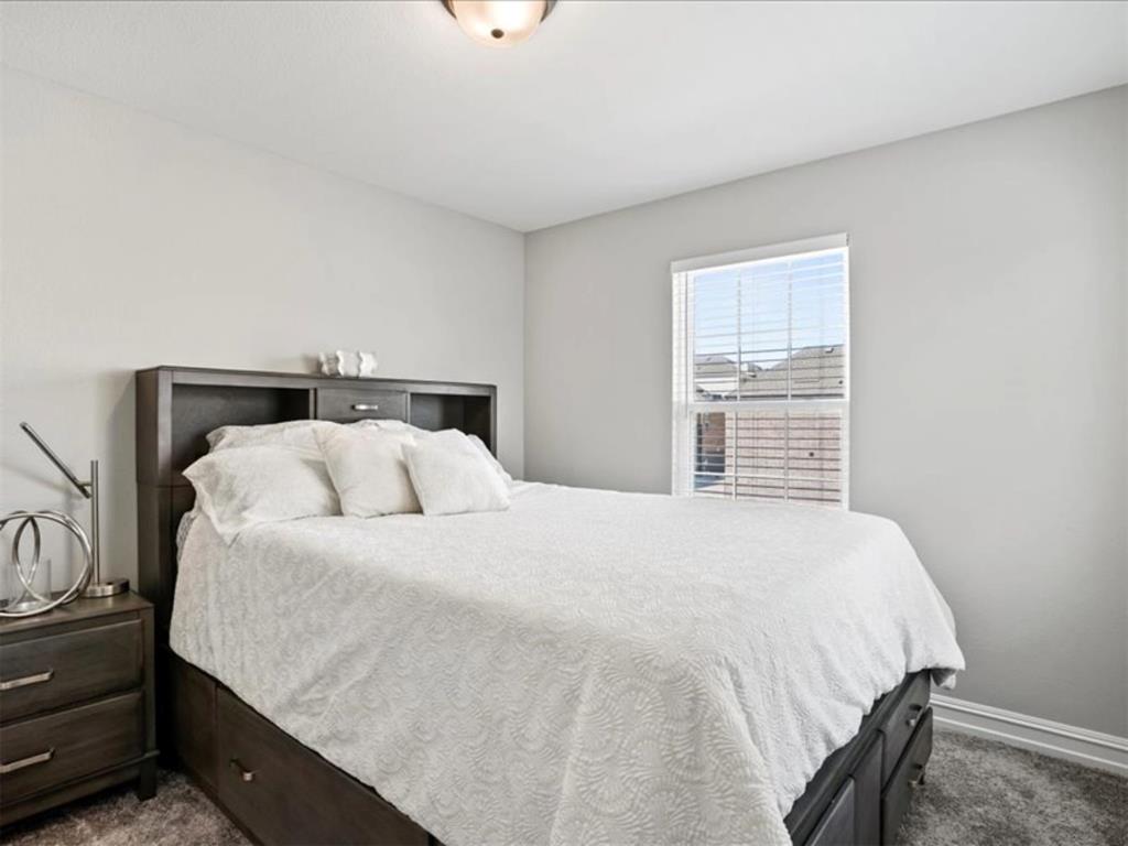 4828 Nicola Road Dallas, TX 75228 - Photo 27 of 38 a large bed sitting in a bedroom next to a window