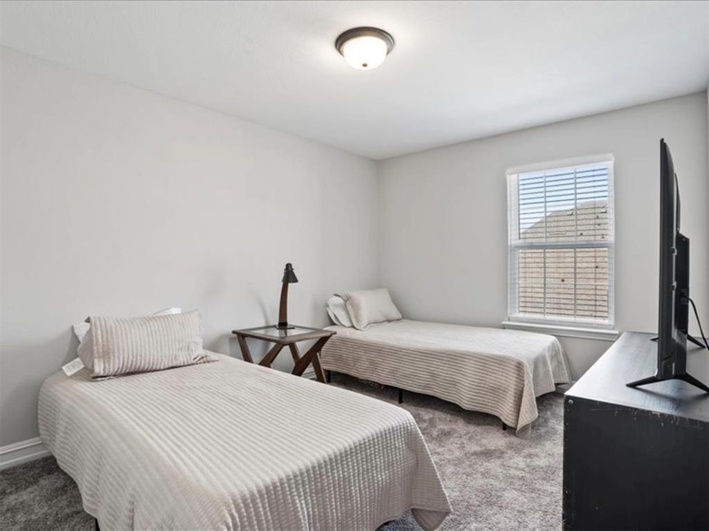 4828 Nicola Road Dallas, TX 75228 - Photo 30 of 38 a bedroom with two beds and a window