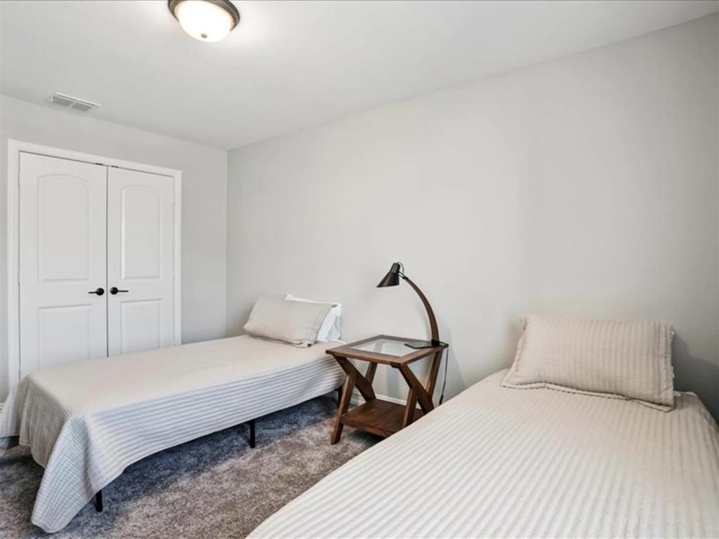 4828 Nicola Road Dallas, TX 75228 - Photo 31 of 38 a bedroom with a bed and a chandelier