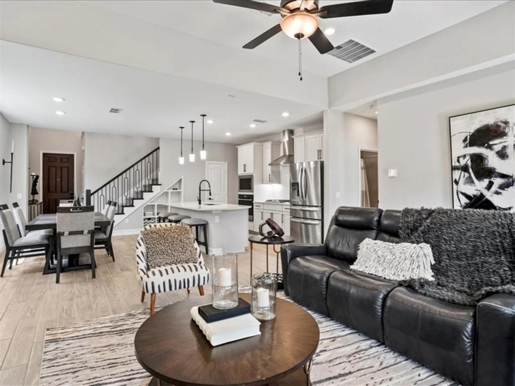 4828 Nicola Road Dallas, TX 75228 - Photo 7 of 38 a living room with furniture kitchen view and a chandelier