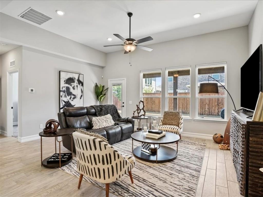 4828 Nicola Road Dallas, TX 75228 - Photo 8 of 38 a living room with furniture a flat screen tv and a chandelier