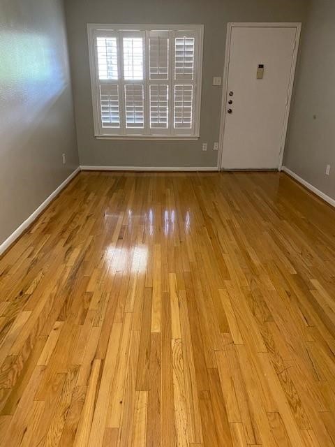 2250 Bering Drive, Unit 98 Houston, TX 77057 - Photo 5 of 14 a view of an empty room with wooden floor and a window