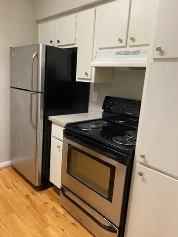 a stove top oven sitting inside of a kitchen