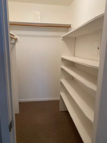 a bathroom with a granite countertop sink mirror vanity and toilet