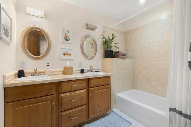 a living room with furniture a piano and a bookshelf