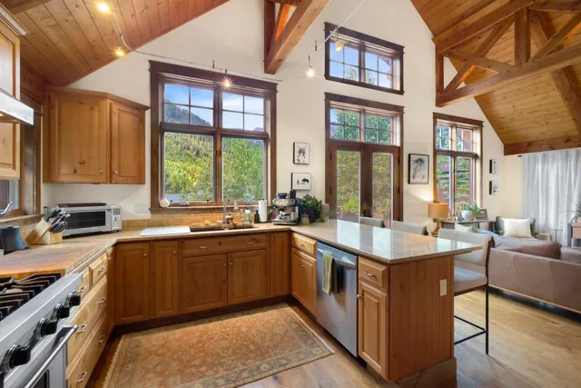 a large kitchen with stainless steel appliances granite countertop a sink and a stove