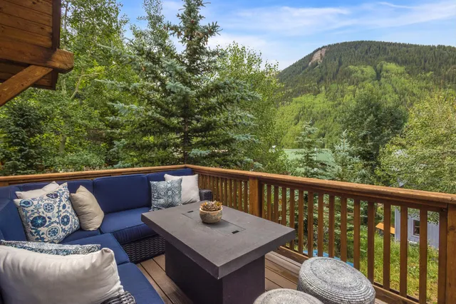 a view of a balcony with couches and wooden floor
