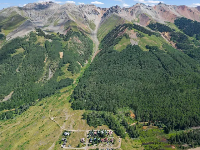 an aerial view of residential houses with outdoor space