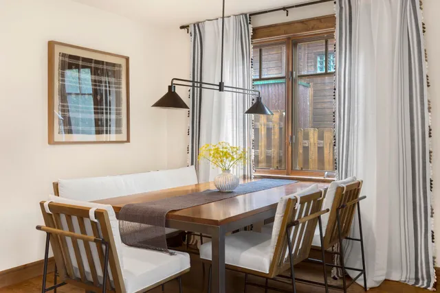 a view of a dining room with furniture and a window