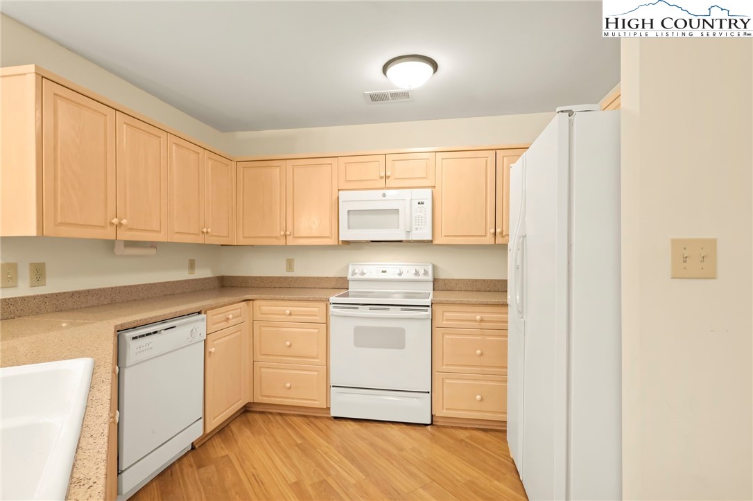 151 Deer Valley Drive, Unit 225 Boone, NC 28607 - Photo 19 of 31 a kitchen with a stove a sink and a refrigerator